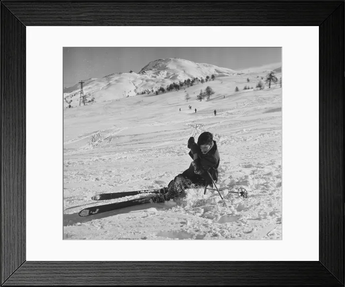 Framed Print : Snow Fall. 1951: A beginner at skiing learns how to get back up on his skis again Framed Print : Snow Fall. 1951: A beginner at skiing learns how to get back up on his skis again