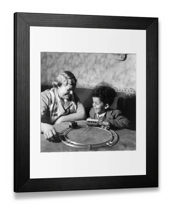 Framed Print : Toy Joy. 22nd April 1950: A woman entertains a young boy with a model railway Framed Print : Toy Joy. 22nd April 1950: A woman entertains a young boy with a model railway