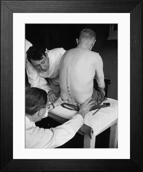 Framed Print : Osteopath. 26th February 1949: A man receiving treatment for an arthritic Framed Print : Osteopath. 26th February 1949: A man receiving treatment for an arthritic