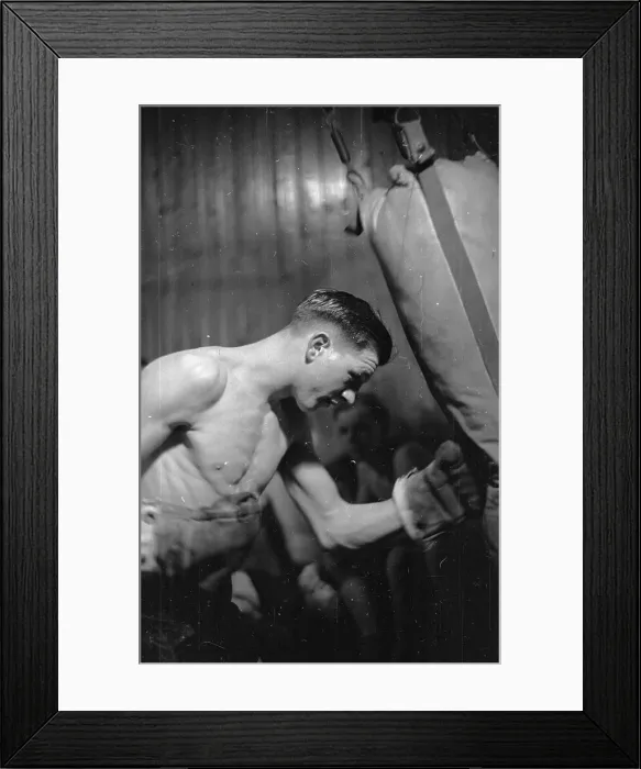 Framed Print : Punch Bag. 13th March 1948: Welsh boxer Eddie Thomas practising with a punch bag Framed Print : Punch Bag. 13th March 1948: Welsh boxer Eddie Thomas practising with a punch bag