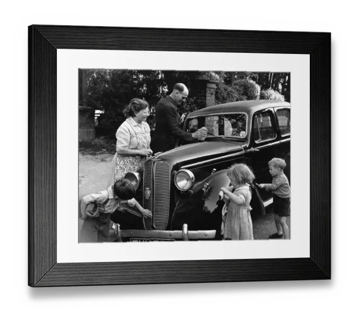 Framed Print : Car Wash. 13th December 1947: A family washing their Hillman car