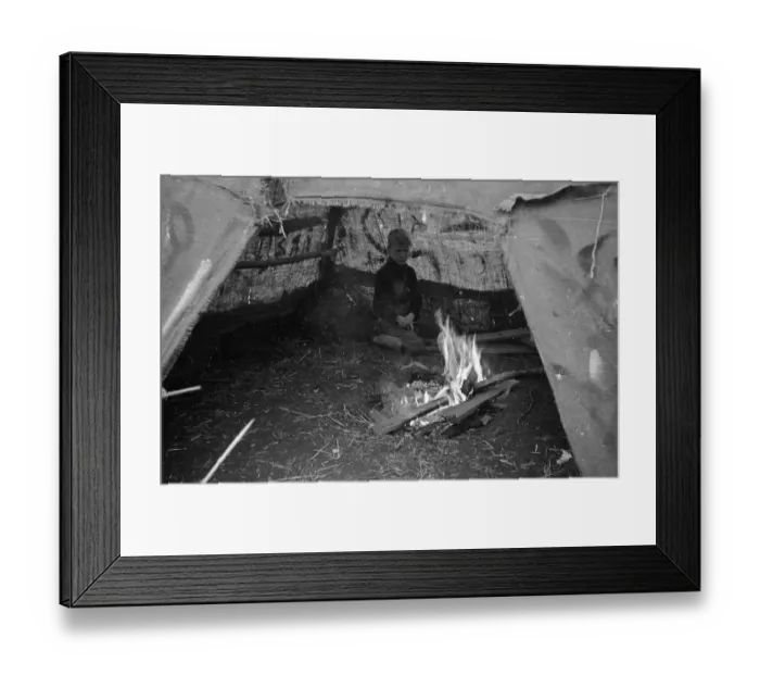 Framed Print : Camp Fire. 16th November 1946: A boy stares into the campfire under the shelter of a tent Framed Print : Camp Fire. 16th November 1946: A boy stares into the campfire under the shelter of a tent