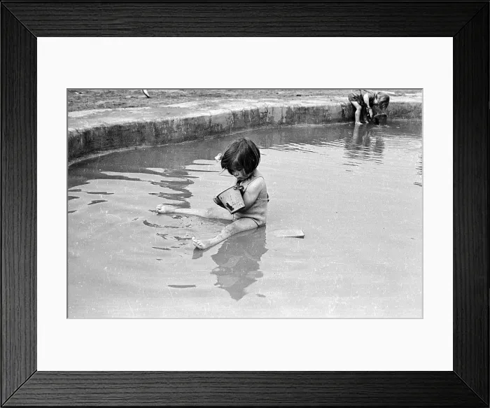 Framed Print : Pond Life. 13th July 1946: A young holidaymaker sitting in a pond at the Framed Print : Pond Life. 13th July 1946: A young holidaymaker sitting in a pond at the