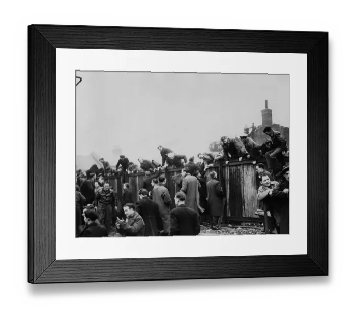 Framed Print : Fans Climb Fence Framed Print : Fans Climb Fence