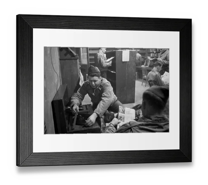 Framed Print : Navy Tune. 25th March 1944: A US marine putting on a record in the library Framed Print : Navy Tune. 25th March 1944: A US marine putting on a record in the library