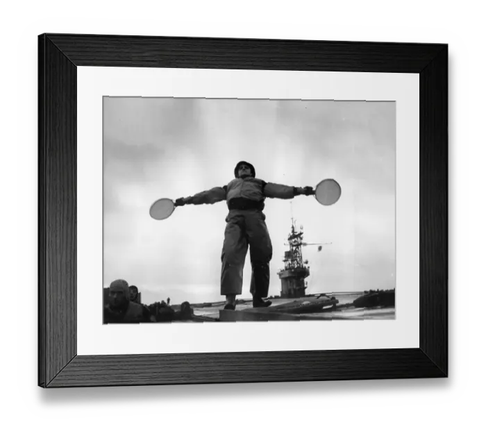 Framed Print : On Course. 15th January 1944: A landing control officer signals with bats Framed Print : On Course. 15th January 1944: A landing control officer signals with bats