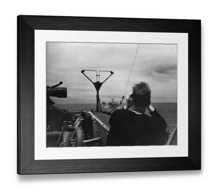 Framed Print : In Convoy. 11th September 1943: A British sailor scans the ships following Framed Print : In Convoy. 11th September 1943: A British sailor scans the ships following