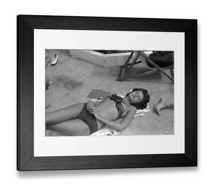 Framed Print : Sunbather. A woman sunbathes next to Roehampton's outdoor swimming pool in South London Framed Print : Sunbather. A woman sunbathes next to Roehampton's outdoor swimming pool in South London