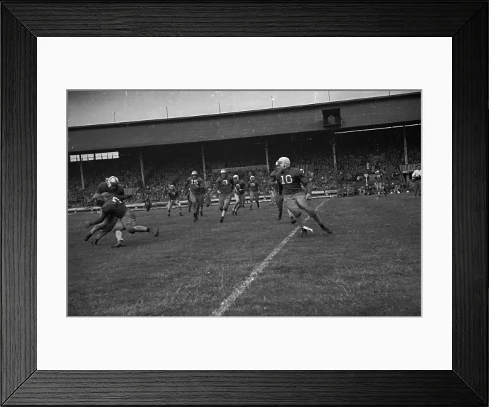 Framed Print : Tackling. An American footballer tackles an opposing player during a game Framed Print : Tackling. An American footballer tackles an opposing player during a game