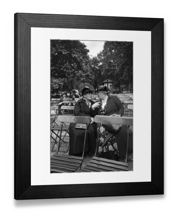 Framed Print : Band Fans. 7th October 1939: Two women gossiping during an interval in Framed Print : Band Fans. 7th October 1939: Two women gossiping during an interval in