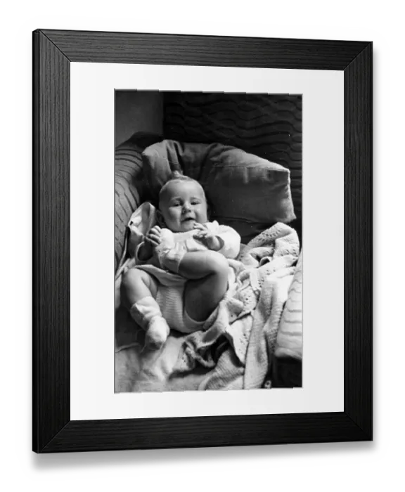 Framed Print : Baby Boy. A baby boy, under the age of one year, lying on a sofa Framed Print : Baby Boy. A baby boy, under the age of one year, lying on a sofa