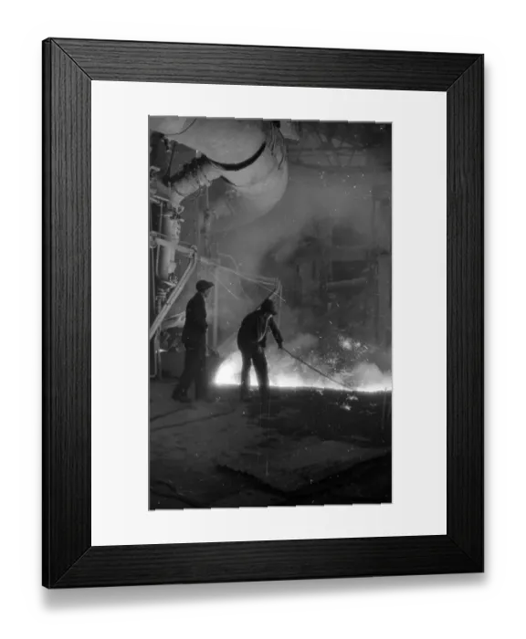 Framed Print : Iron Test. 29th April 1939: A steelworker uses a ladle to test the grade Framed Print : Iron Test. 29th April 1939: A steelworker uses a ladle to test the grade