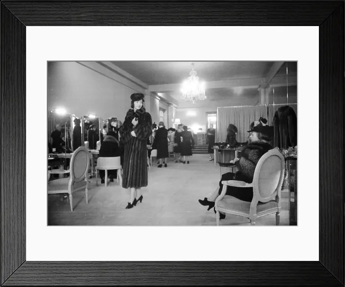 Framed Print : Fur Sale. 19th November 1938: A model shows a customer a mink fur coat