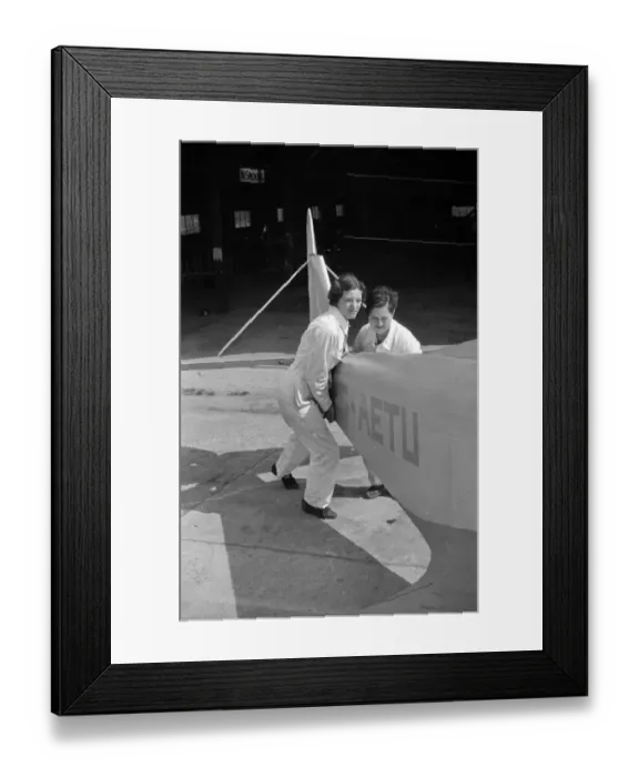 Framed Print : Air Women. 22nd October 1938: Pushing the plane back in its hangar after Framed Print : Air Women. 22nd October 1938: Pushing the plane back in its hangar after