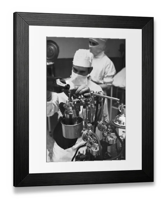 Framed Print : Gas Pump. 1st October 1938: An anaesthetist prepares his equipment for Framed Print : Gas Pump. 1st October 1938: An anaesthetist prepares his equipment for