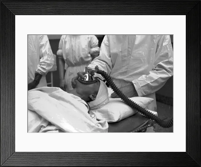 Framed Print : Gas Man. 1st October 1938: An anaesthetist applying a mask to a patient's