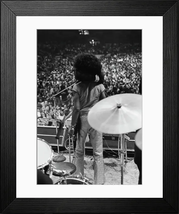 Framed Print : Showtime. Performer Sly Stone in glittery trousers surveys the crowd at a concert Framed Print : Showtime. Performer Sly Stone in glittery trousers surveys the crowd at a concert