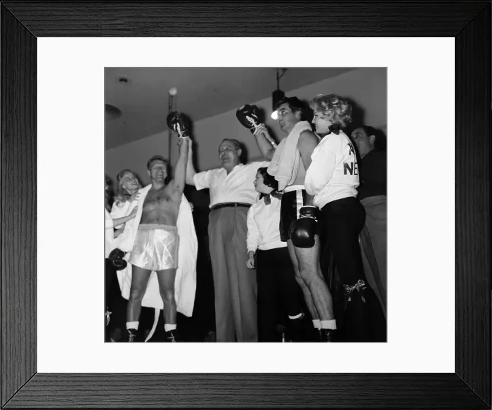 Framed Print : Boxing. LOS ANGELES, CA - CIRCA 1957: A ring judge holds up the hands of Framed Print : Boxing. LOS ANGELES, CA - CIRCA 1957: A ring judge holds up the hands of