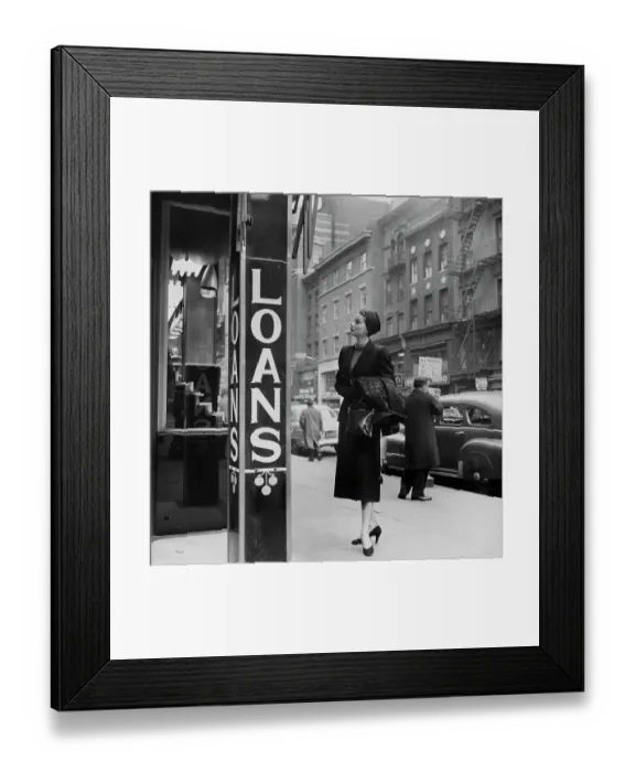 Framed Print : Loans. An elegantly-dressed woman looking in a shop window which advertises loans Framed Print : Loans. An elegantly-dressed woman looking in a shop window which advertises loans