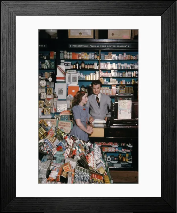 Framed Print : Pharmacy. NEW YORK - SEPTEMBER 1941: A Pharmacist serves customers in September Framed Print : Pharmacy. NEW YORK - SEPTEMBER 1941: A Pharmacist serves customers in September