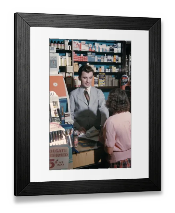 Framed Print : Pharmacy. NEW YORK - SEPTEMBER 1941: A Pharmacist serves customers in September Framed Print : Pharmacy. NEW YORK - SEPTEMBER 1941: A Pharmacist serves customers in September