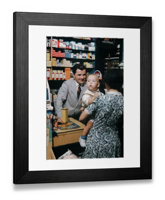 Framed Print : Pharmacy. NEW YORK - SEPTEMBER 1941: A Pharmacist serves customers in September Framed Print : Pharmacy. NEW YORK - SEPTEMBER 1941: A Pharmacist serves customers in September