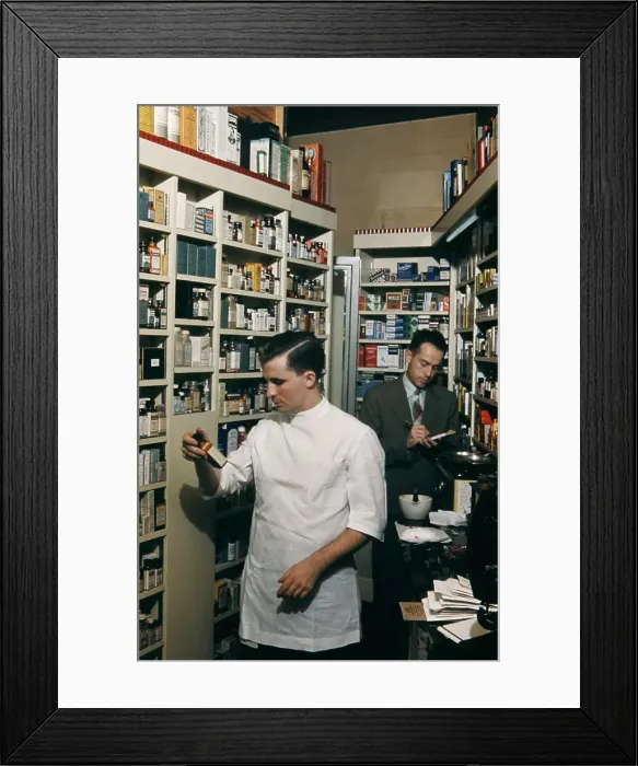Framed Print : Pharmacy. NEW YORK - SEPTEMBER 1941: A Pharmacist prepares a prescription Framed Print : Pharmacy. NEW YORK - SEPTEMBER 1941: A Pharmacist prepares a prescription