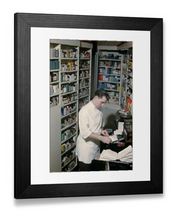 Framed Print : Pharmacy. NEW YORK - SEPTEMBER 1941: A Pharmacist prepares a prescription Framed Print : Pharmacy. NEW YORK - SEPTEMBER 1941: A Pharmacist prepares a prescription