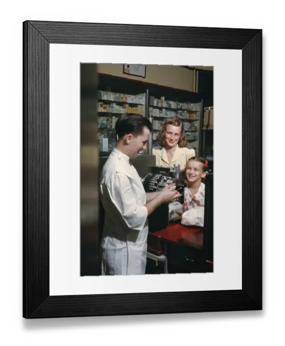 Framed Print : Pharmacy. NEW YORK - SEPTEMBER 1941: A Pharmacist serves customers in September Framed Print : Pharmacy. NEW YORK - SEPTEMBER 1941: A Pharmacist serves customers in September