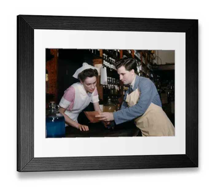 Framed Print : Pharmacy. NEW YORK - SEPTEMBER 1941: A Pharmacist consults with his assistant Framed Print : Pharmacy. NEW YORK - SEPTEMBER 1941: A Pharmacist consults with his assistant