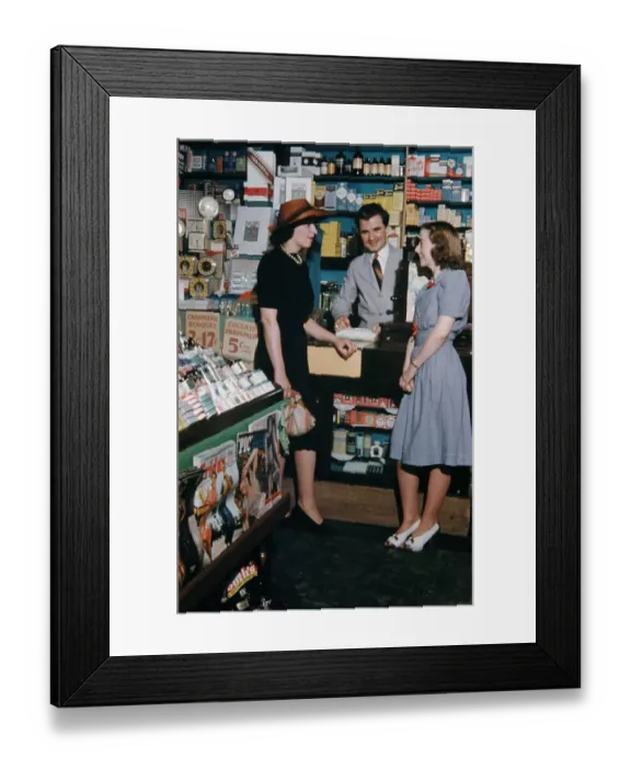 Framed Print : Pharmacy. NEW YORK - SEPTEMBER 1941: A Pharmacist serves customers in September Framed Print : Pharmacy. NEW YORK - SEPTEMBER 1941: A Pharmacist serves customers in September