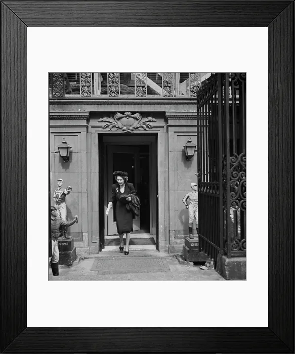 Framed Print : 21 Club. A woman leaving the 21 Club, restaurant on West 52nd Street in New York City Framed Print : 21 Club. A woman leaving the 21 Club, restaurant on West 52nd Street in New York City