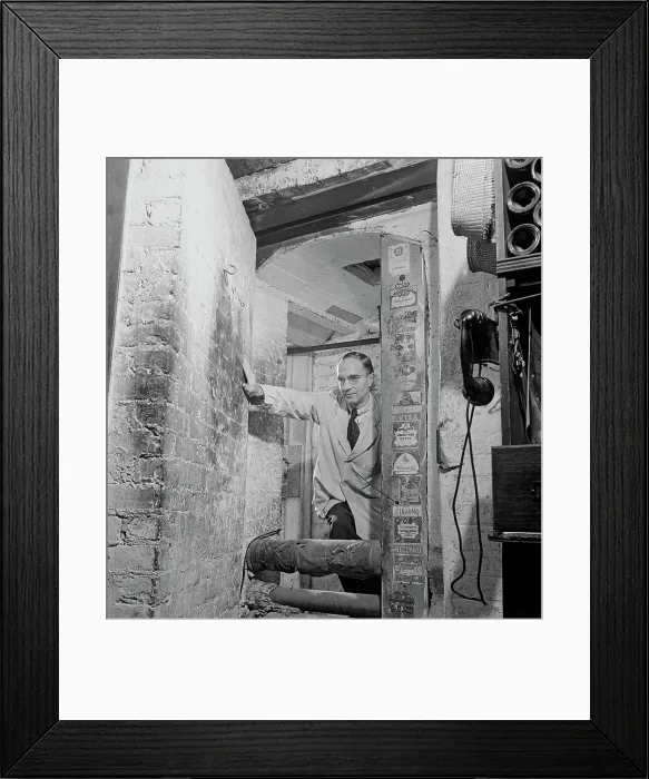 Framed Print : 21 Club. A waiter leaving the wine cellar at the 21 Club restaurant Framed Print : 21 Club. A waiter leaving the wine cellar at the 21 Club restaurant