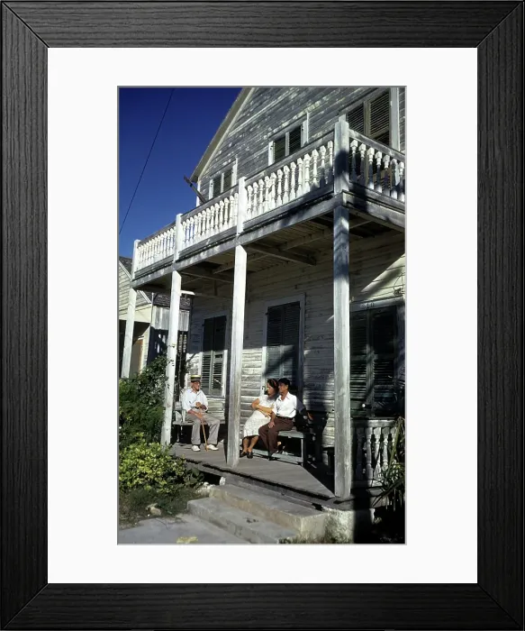 Framed Print : KEY WEST, FL - CIRCA 1946: A view as a couple sit on the front porch of a home in Key West Framed Print : KEY WEST, FL - CIRCA 1946: A view as a couple sit on the front porch of a home in Key West