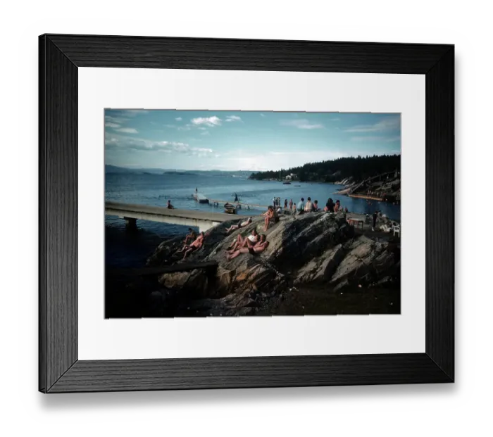 Framed Print : NORWAY - JULY 1946: A view as couples sunbathe on a rock in Norway Framed Print : NORWAY - JULY 1946: A view as couples sunbathe on a rock in Norway