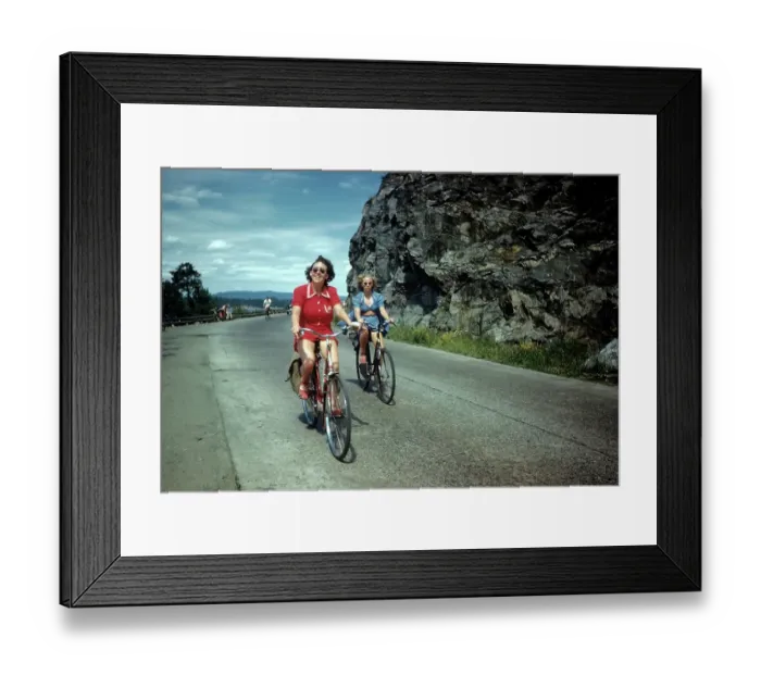 Framed Print : NORWAY - JULY 1946: A view as a couple rides their bike in Norway Framed Print : NORWAY - JULY 1946: A view as a couple rides their bike in Norway