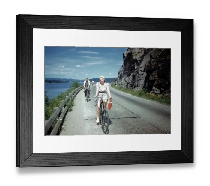 Framed Print : NORWAY - JULY 1946: A view as a couple rides their bike in Norway Framed Print : NORWAY - JULY 1946: A view as a couple rides their bike in Norway