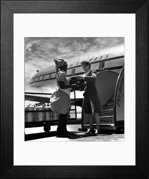 Framed Print : Pan Am. PORT-AU-PRINCE, HAITI - CIRCA 1947: An airport worker hands boxes Framed Print : Pan Am. PORT-AU-PRINCE, HAITI - CIRCA 1947: An airport worker hands boxes