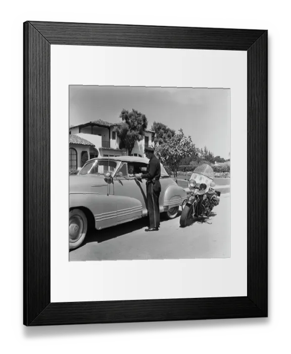 Framed Print : Cycle Cop. A motorcycle policeman checking the driving licence of a man Framed Print : Cycle Cop. A motorcycle policeman checking the driving licence of a man