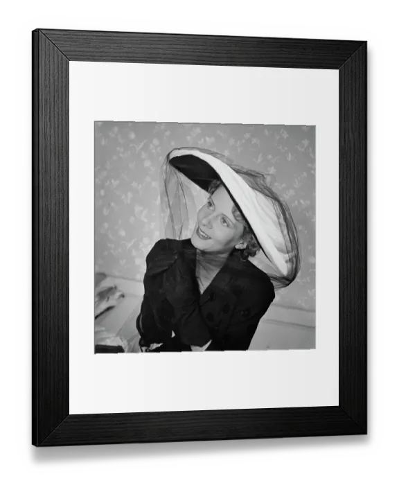 Framed Print : Très Chic. A female model wearing a dark polka-dot v-neck outfit with dark gloves Framed Print : Très Chic. A female model wearing a dark polka-dot v-neck outfit with dark gloves