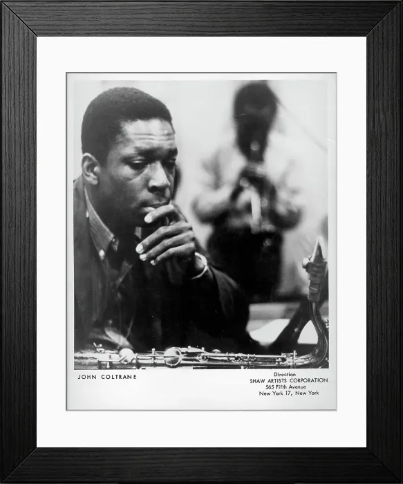 Framed Print : Listening. CIRCA 1961: Jazz saxophonist John Coltrane listens as a man Framed Print : Listening. CIRCA 1961: Jazz saxophonist John Coltrane listens as a man