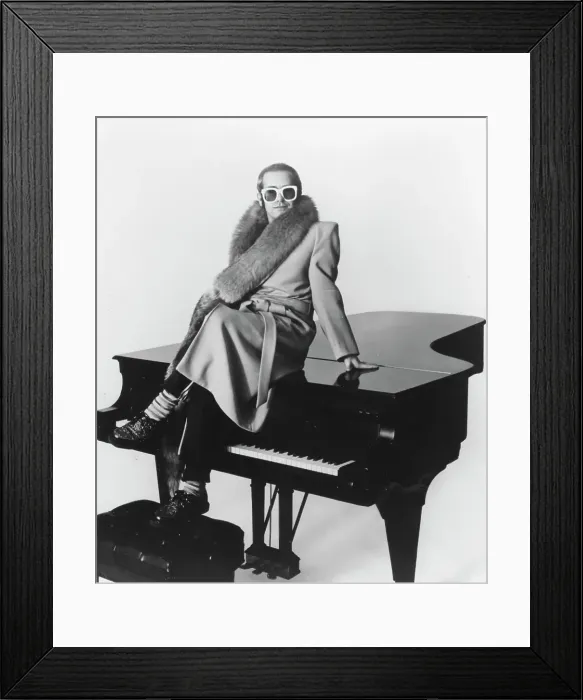 Framed Print : Piano Man. CIRCA 1974: Pop singer Elton John poses for a portrait sitting Framed Print : Piano Man. CIRCA 1974: Pop singer Elton John poses for a portrait sitting