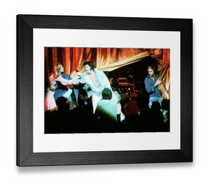 Framed Print : Elvis Presley with a fan in front of the curtains Framed Print : Elvis Presley with a fan in front of the curtains