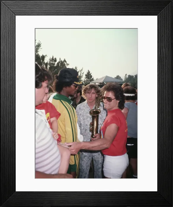 Framed Print : Joe Walsh. American rock guitarist Joe Walsh (centre) holding a saxophone, 1983 Framed Print : Joe Walsh. American rock guitarist Joe Walsh (centre) holding a saxophone, 1983