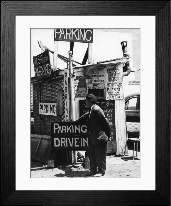 Framed Print : Car Park. BROOKLYN, NY - MARCH 1958: A car park attendant stands by his Framed Print : Car Park. BROOKLYN, NY - MARCH 1958: A car park attendant stands by his