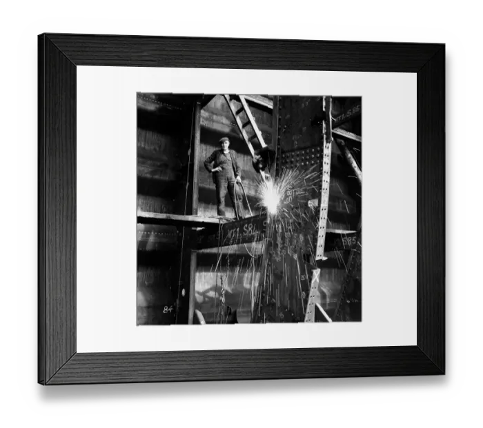 Framed Print : Welder on beam in shipyard, portrait (B&W) Framed Print : Welder on beam in shipyard, portrait (B&W)