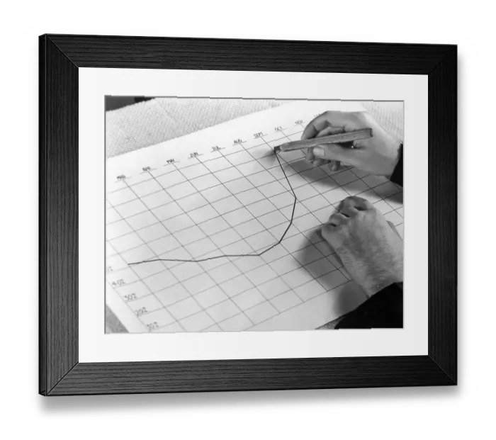 Framed Print : On The Up. circa 1945: A man's hand charts a monthly business curve on Framed Print : On The Up. circa 1945: A man's hand charts a monthly business curve on