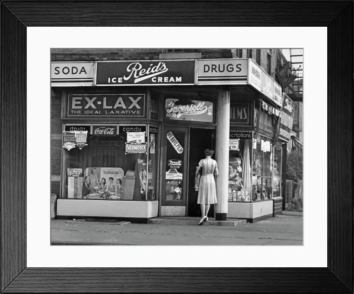 Framed Print : Drugstore. Exterior view of the Ingersoll pharmacy with advertising signs, 1940s Framed Print : Drugstore. Exterior view of the Ingersoll pharmacy with advertising signs, 1940s