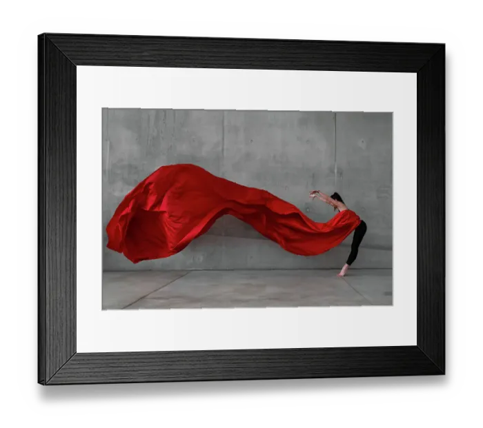 Framed Print : Female ballet dancer on pointes dancing with a large red veil in front of a grey concrete wall Framed Print : Female ballet dancer on pointes dancing with a large red veil in front of a grey concrete wall