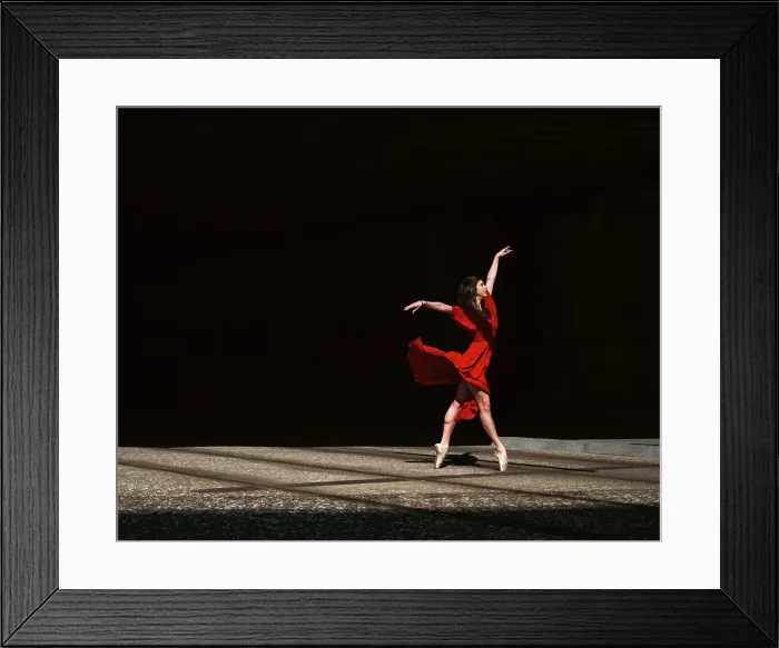 Framed Print : Female ballet dancer dancing with pointes in the street with a long red dress Framed Print : Female ballet dancer dancing with pointes in the street with a long red dress
